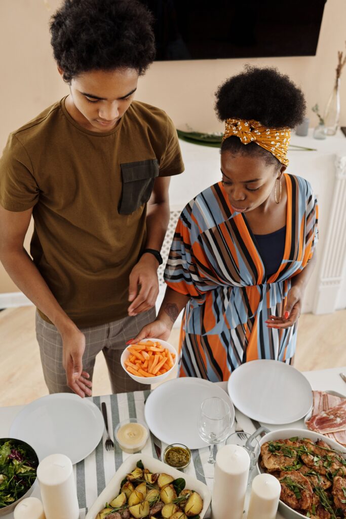 mother and teenage son cooking together in a kitchen